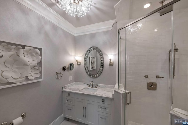 bathroom with crown molding, vanity, and walk in shower