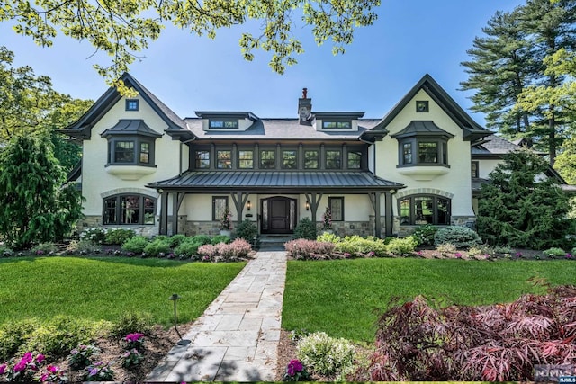 view of front of property with covered porch and a front lawn