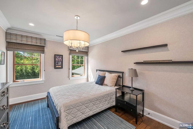 bedroom with a chandelier, crown molding, and dark wood-type flooring