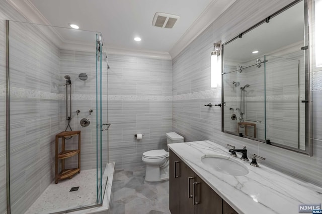 bathroom featuring walk in shower, vanity, tile walls, and ornamental molding