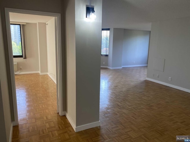 hall featuring dark parquet flooring