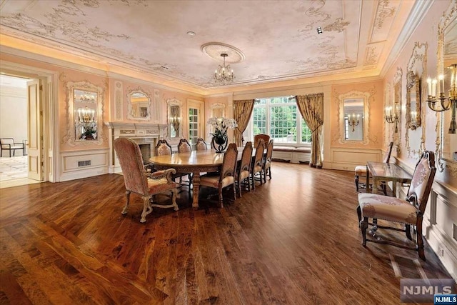 dining space with dark hardwood / wood-style flooring and crown molding