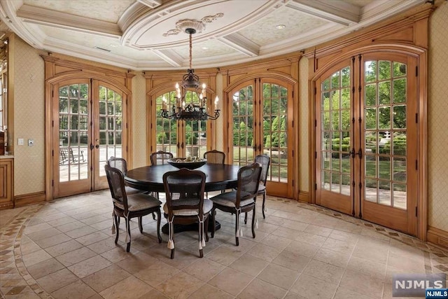 sunroom featuring coffered ceiling, a chandelier, a healthy amount of sunlight, and french doors