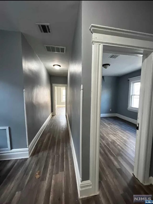 corridor with dark hardwood / wood-style floors