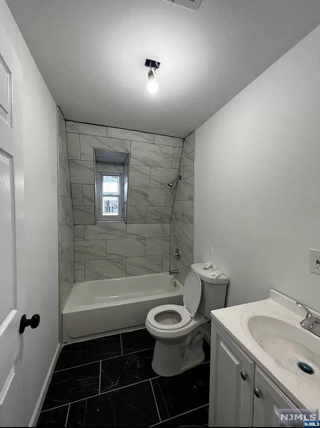 full bathroom with vanity, toilet, and tiled shower / bath