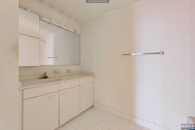 bathroom featuring tile patterned flooring and vanity