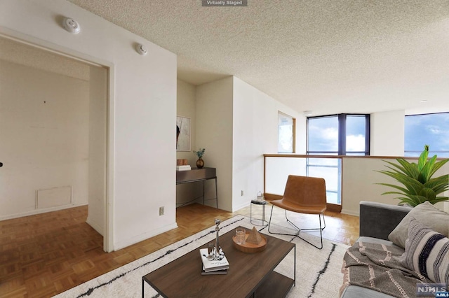 living room with parquet floors and a textured ceiling