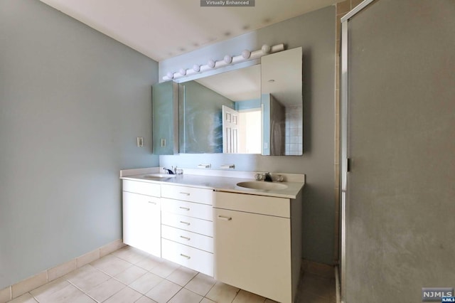 bathroom featuring tile patterned flooring, vanity, and a shower with door