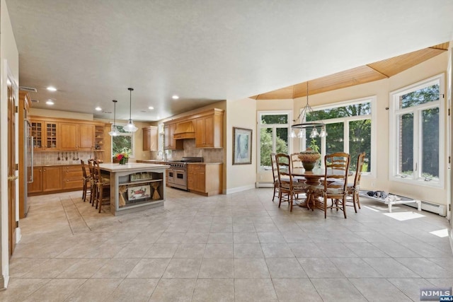 kitchen featuring light tile patterned flooring, decorative backsplash, a kitchen island, and double oven range