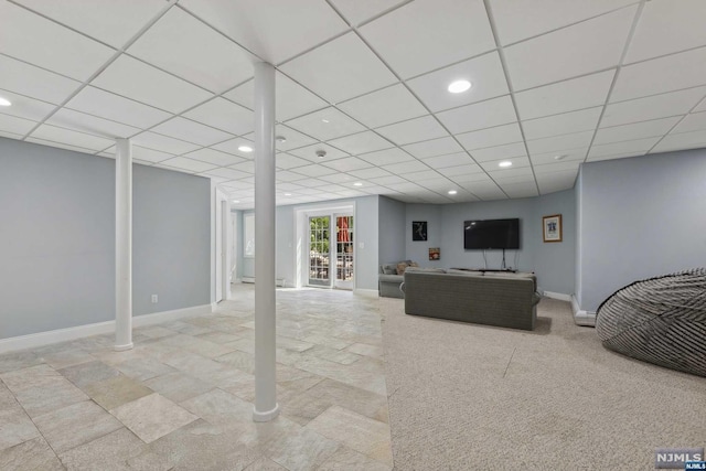 living room with a drop ceiling