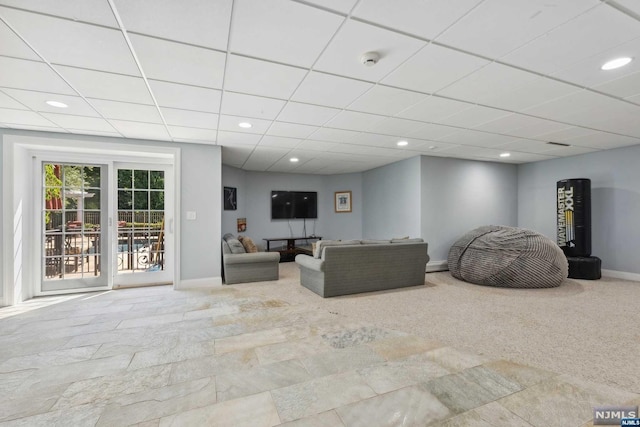 living room featuring a drop ceiling