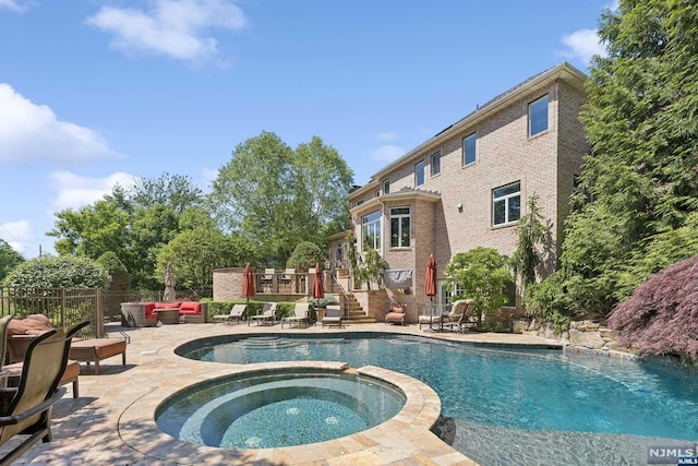 view of swimming pool featuring outdoor lounge area, an in ground hot tub, and a patio