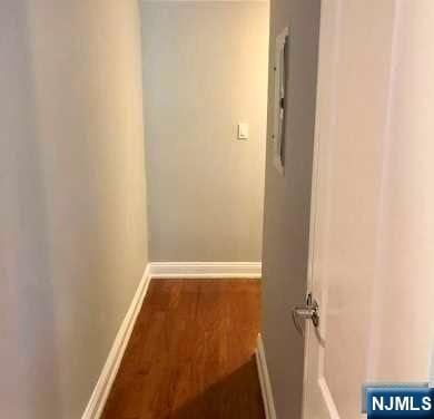 hallway with hardwood / wood-style floors