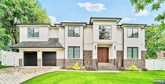 view of front of house with a front yard and a garage