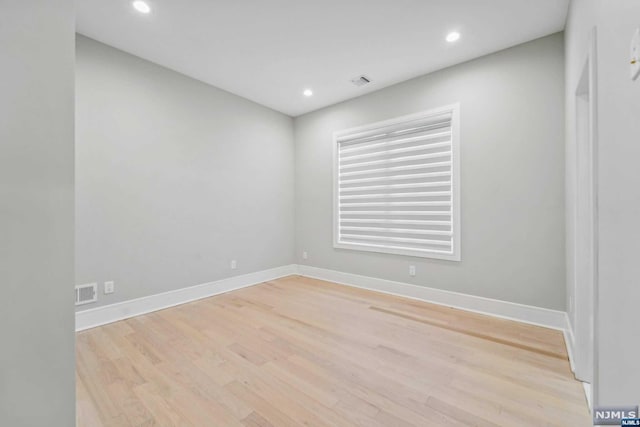 spare room featuring light hardwood / wood-style floors