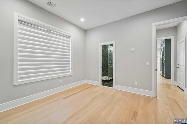 empty room with light hardwood / wood-style floors