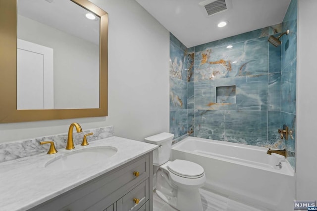 full bathroom with vanity, toilet, and tiled shower / bath