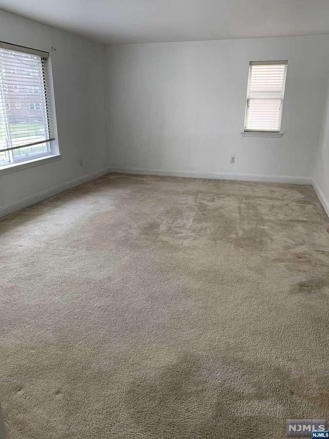 empty room featuring light carpet