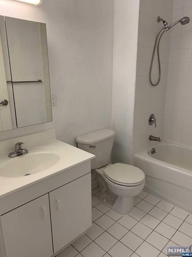 full bathroom featuring tile patterned flooring, vanity, toilet, and tiled shower / bath