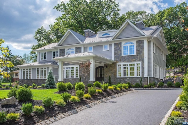 craftsman inspired home with a front lawn