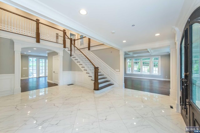 interior space with french doors, ornate columns, crown molding, and plenty of natural light