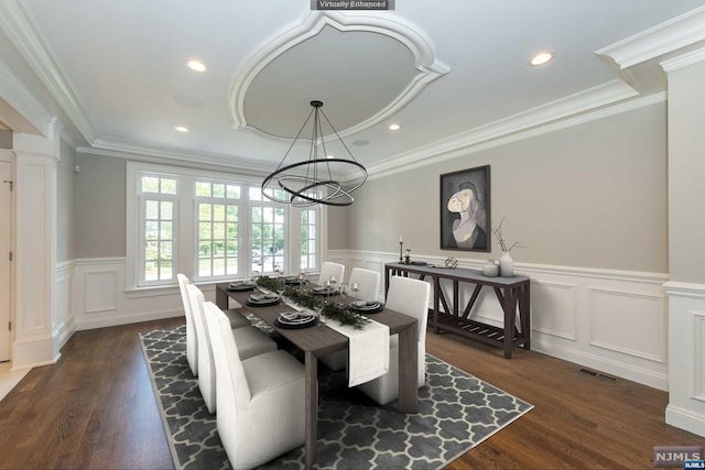 dining room featuring dark wood-type flooring, ornamental molding, and an inviting chandelier