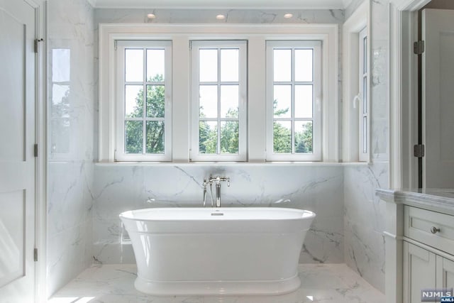 bathroom with a bathing tub and plenty of natural light