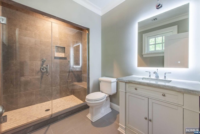 bathroom with toilet, tile patterned flooring, a shower with door, and vanity