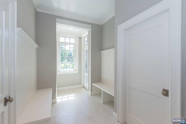 mudroom featuring light tile patterned floors and ornamental molding