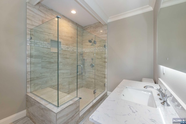 bathroom featuring walk in shower, ornamental molding, and vanity