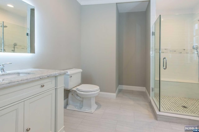 bathroom featuring a shower with door, toilet, vanity, and tile patterned flooring