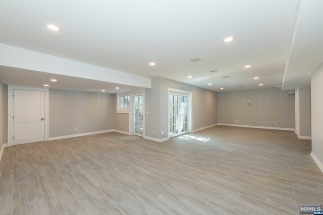 basement with light hardwood / wood-style flooring