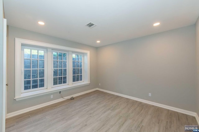 unfurnished room with light hardwood / wood-style flooring