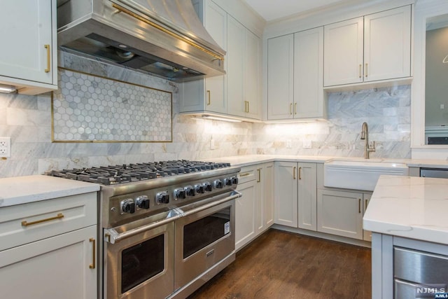 kitchen with white cabinetry, premium range hood, range with two ovens, and backsplash