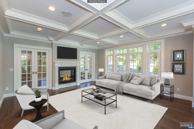 living room featuring a healthy amount of sunlight, french doors, and coffered ceiling