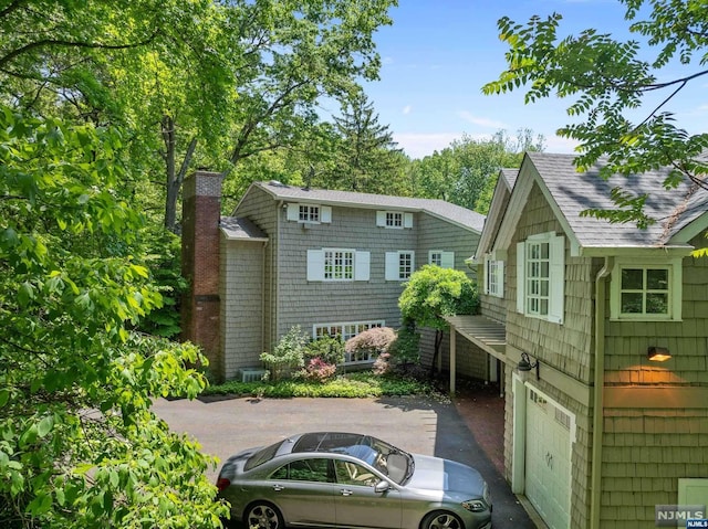 back of house featuring a garage