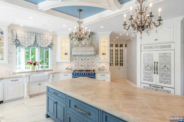 kitchen featuring range with gas cooktop, white cabinetry, blue cabinetry, custom range hood, and french doors