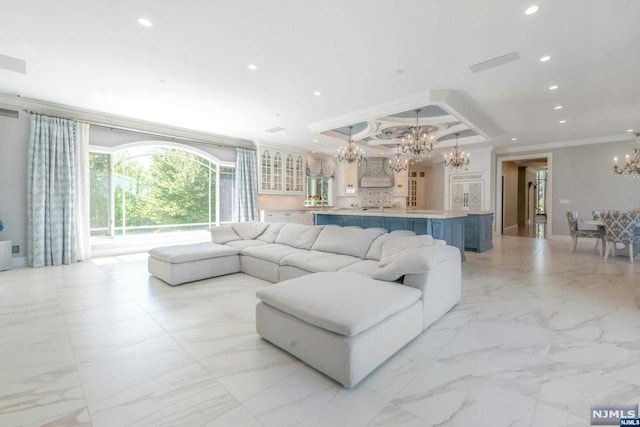 living room featuring a chandelier and crown molding