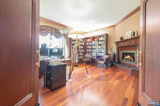 office area with ornamental molding and hardwood / wood-style floors