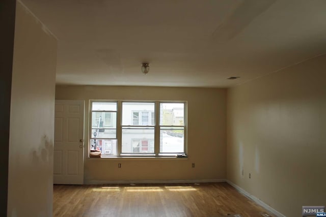 unfurnished room featuring light hardwood / wood-style flooring