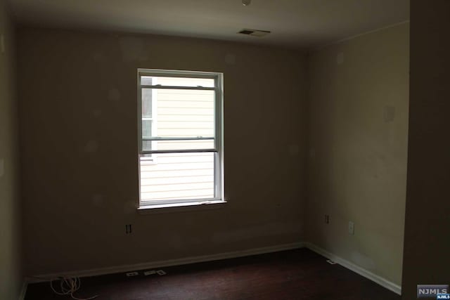 spare room featuring dark hardwood / wood-style floors