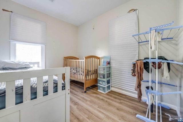 bedroom with wood-type flooring