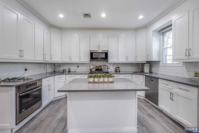 kitchen with white cabinetry, light hardwood / wood-style flooring, and appliances with stainless steel finishes