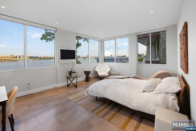 bedroom featuring tile patterned floors and multiple windows