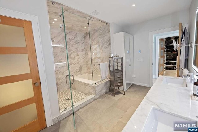 bathroom featuring tile patterned floors, vanity, and separate shower and tub