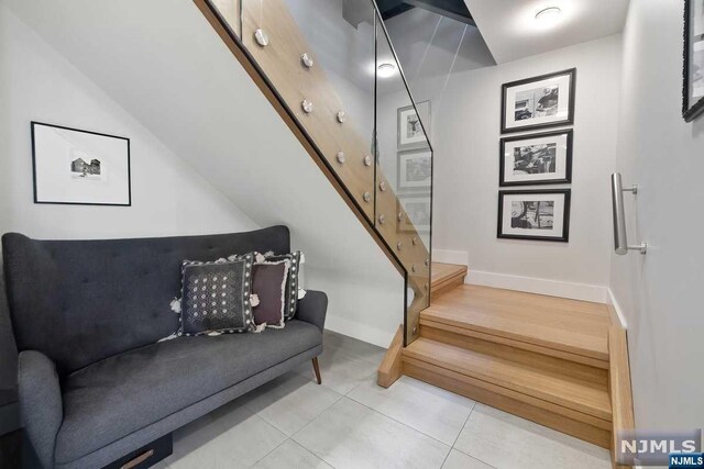 stairway featuring tile patterned flooring