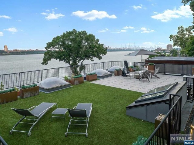 view of yard featuring a water view and a patio