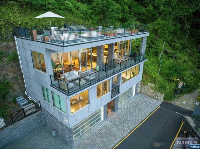 rear view of property featuring a balcony