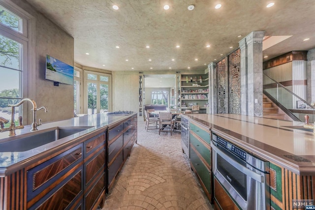 kitchen featuring carpet flooring and sink