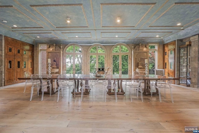 interior space with coffered ceiling and light wood-type flooring